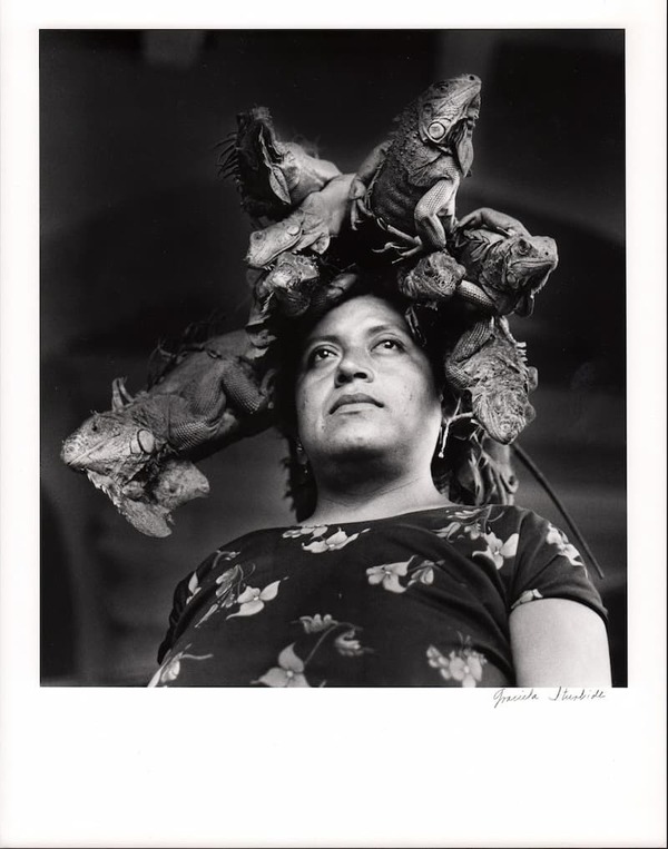 Photograph. Title: Nuestra Senora De Las Iguanas. Photographer: Graciela Iturbide.
Black and white photograph of a woman with iguanas on her head.