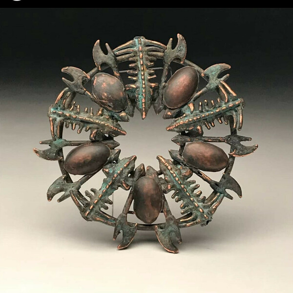 Round object of a repeating pattern of a organic object with pincer like claws. Artwork by Jack Christeon.