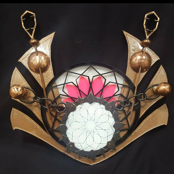 Round object with spikes held in place by chains affixed to two knobs. Artwork by Jack Christeon.