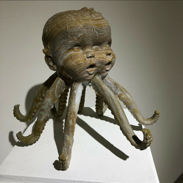 Artwork of Split face of baby doll on octopus tentacles for legs by Jack Christeon.